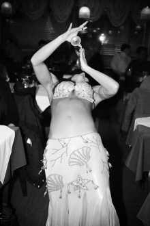 Sasha bellydancing at a restaurant.